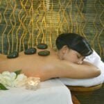 Woman receiving warm stone therapy at a spa in Bali in Seminyak