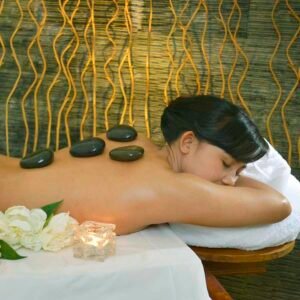 Woman receiving warm stone therapy at a spa in Bali in Seminyak